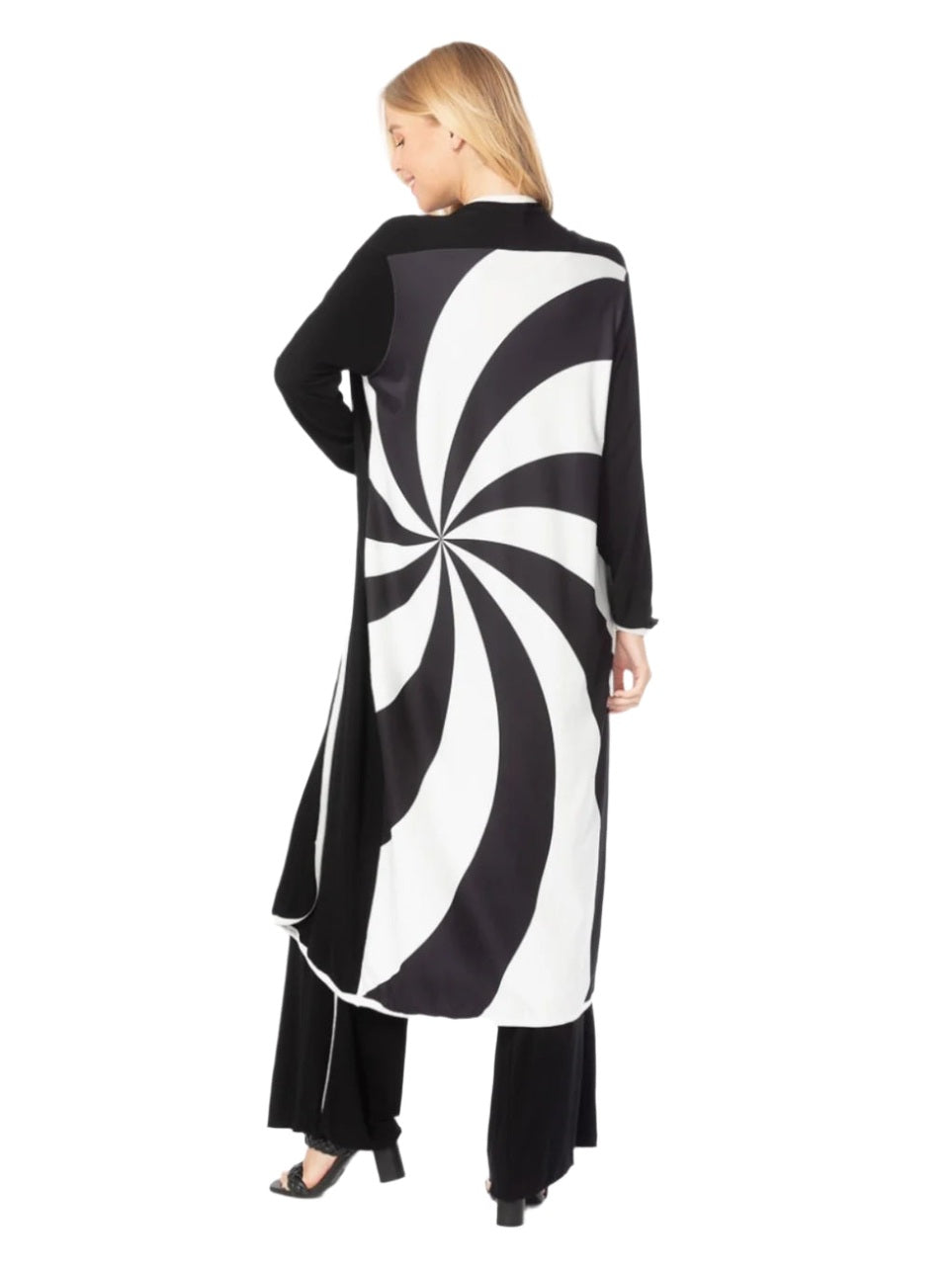 Woman wearing a black and white patterned dress on a white background