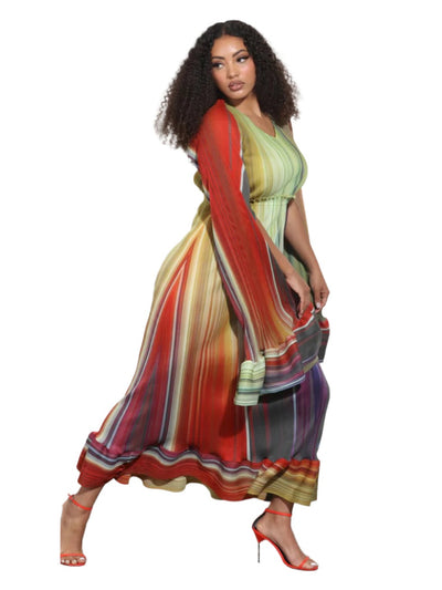 Woman wearing a colorful dress with a white wall background