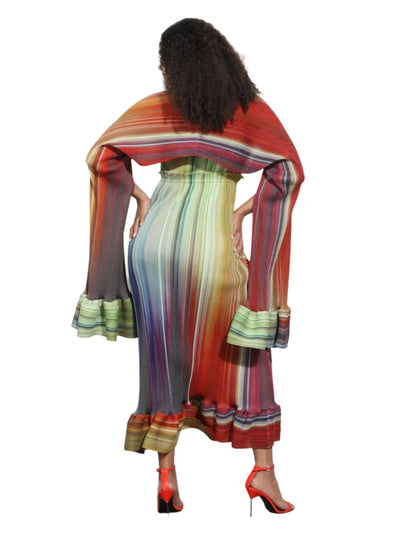 Woman wearing a colorful striped dress with a patterned shawl.