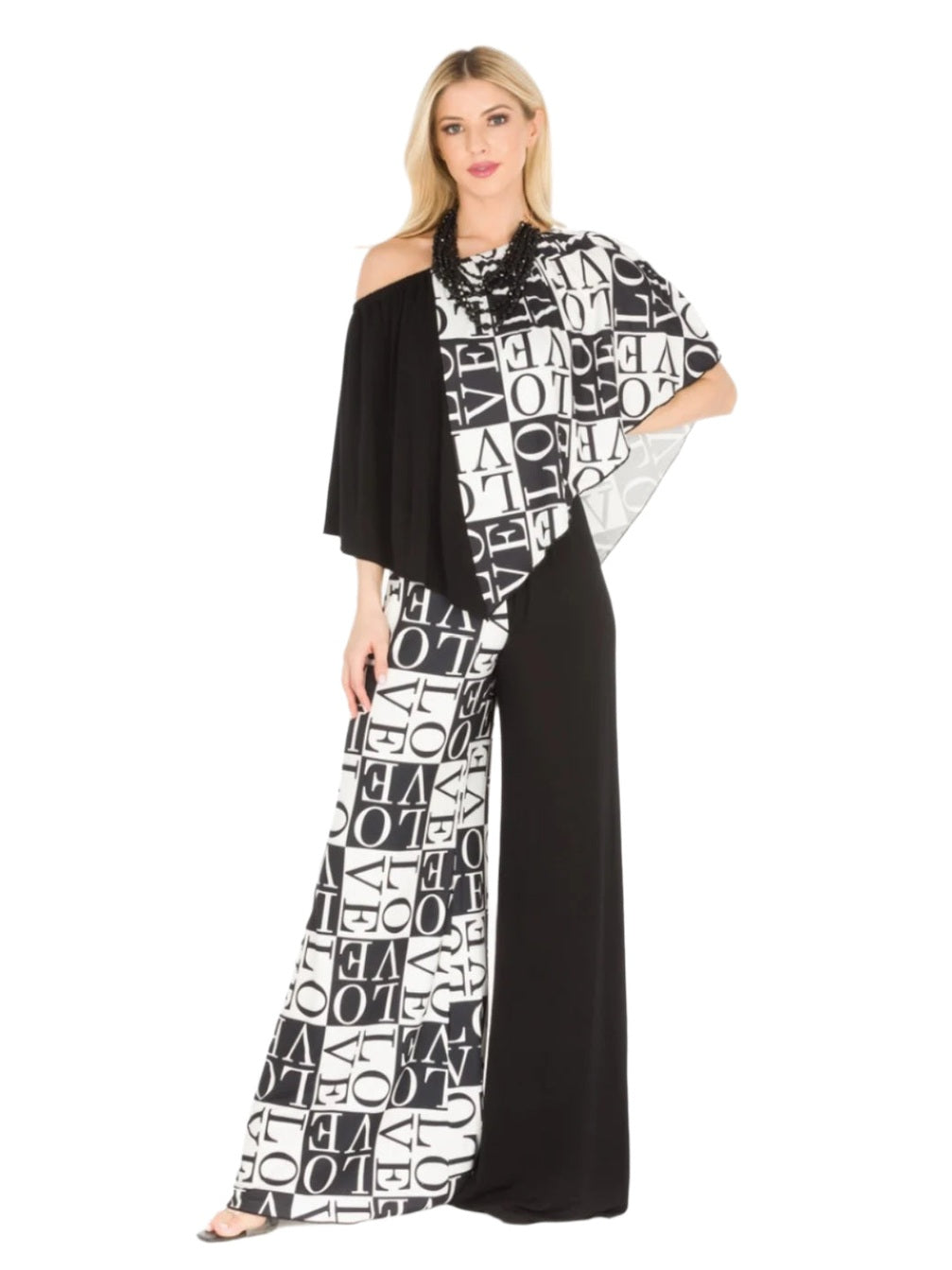 Woman wearing a black and white patterned dress with 'LOVE' letters on a white background